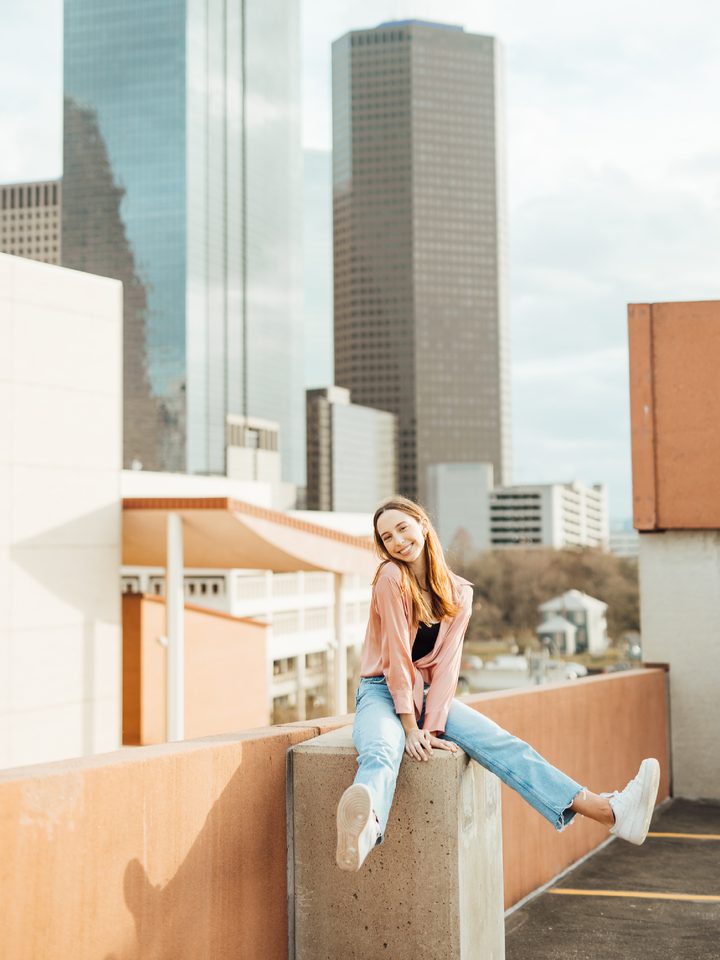 A high school senior photographed on a downtown Houston rooftop