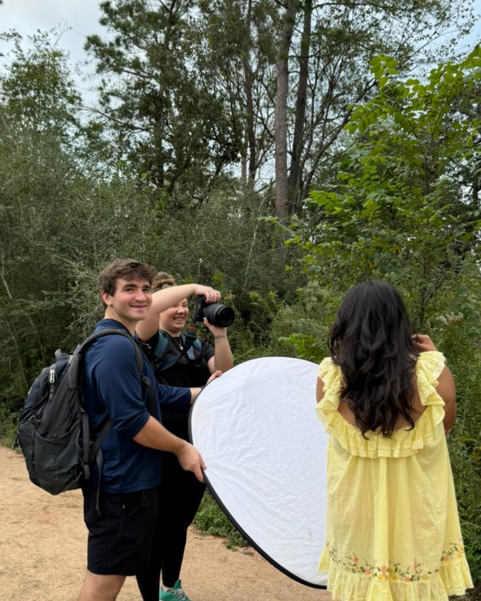 Reed and another photographer shooting a senior in a field